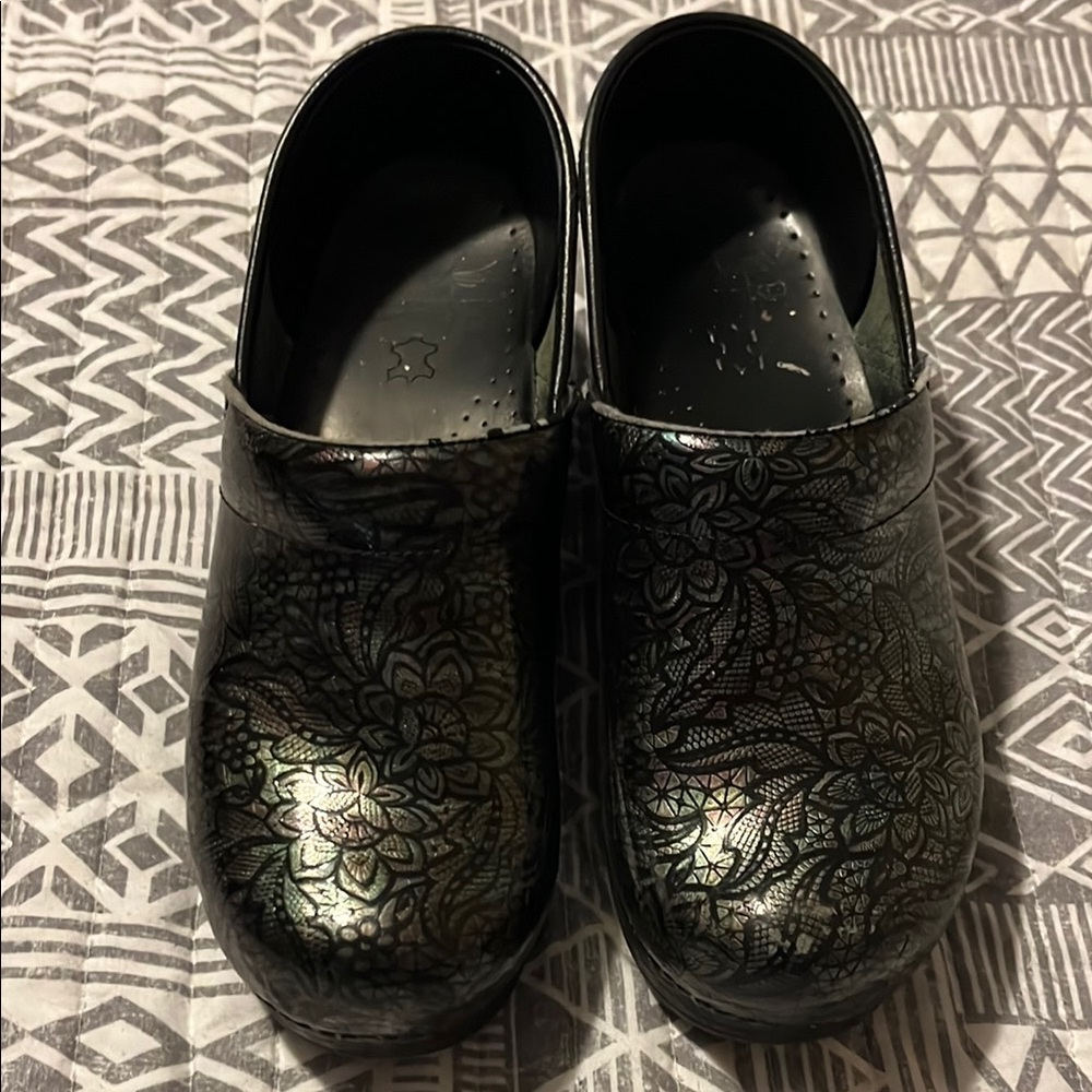 Dansko black floral clogs.